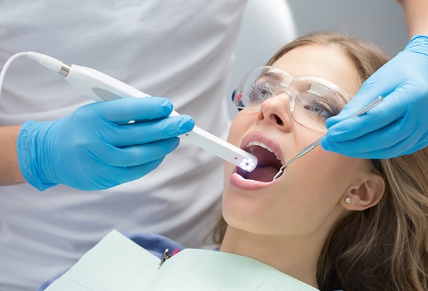 Dentist using intraoral camera to capture smile images