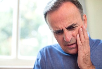 Man experiencing tooth pain in Beverly Hills