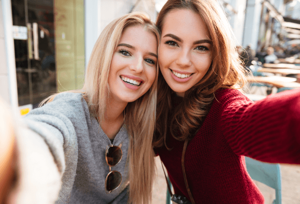 Two women smiling after cosmetic dental bonding treatment