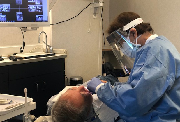 Dentist performing preventive dentistry exam