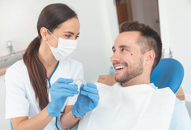 dentist in Beverly Hills showing a patient how Invisalign® works