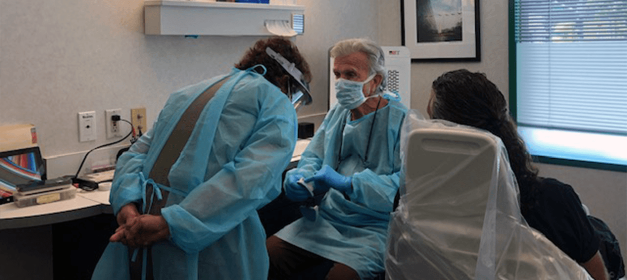 Doctor Davidson showing detnal team member and dentistry patient a smile model