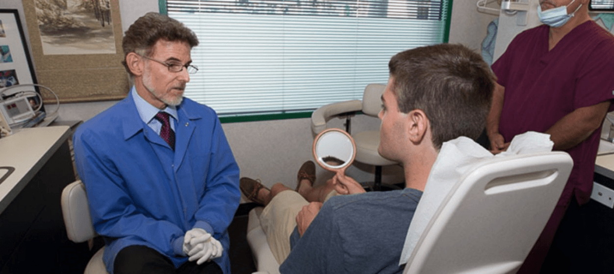 Doctor Strom talking to a patient in a dental treatment room